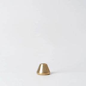 Small brass cone-shaped object on a white background