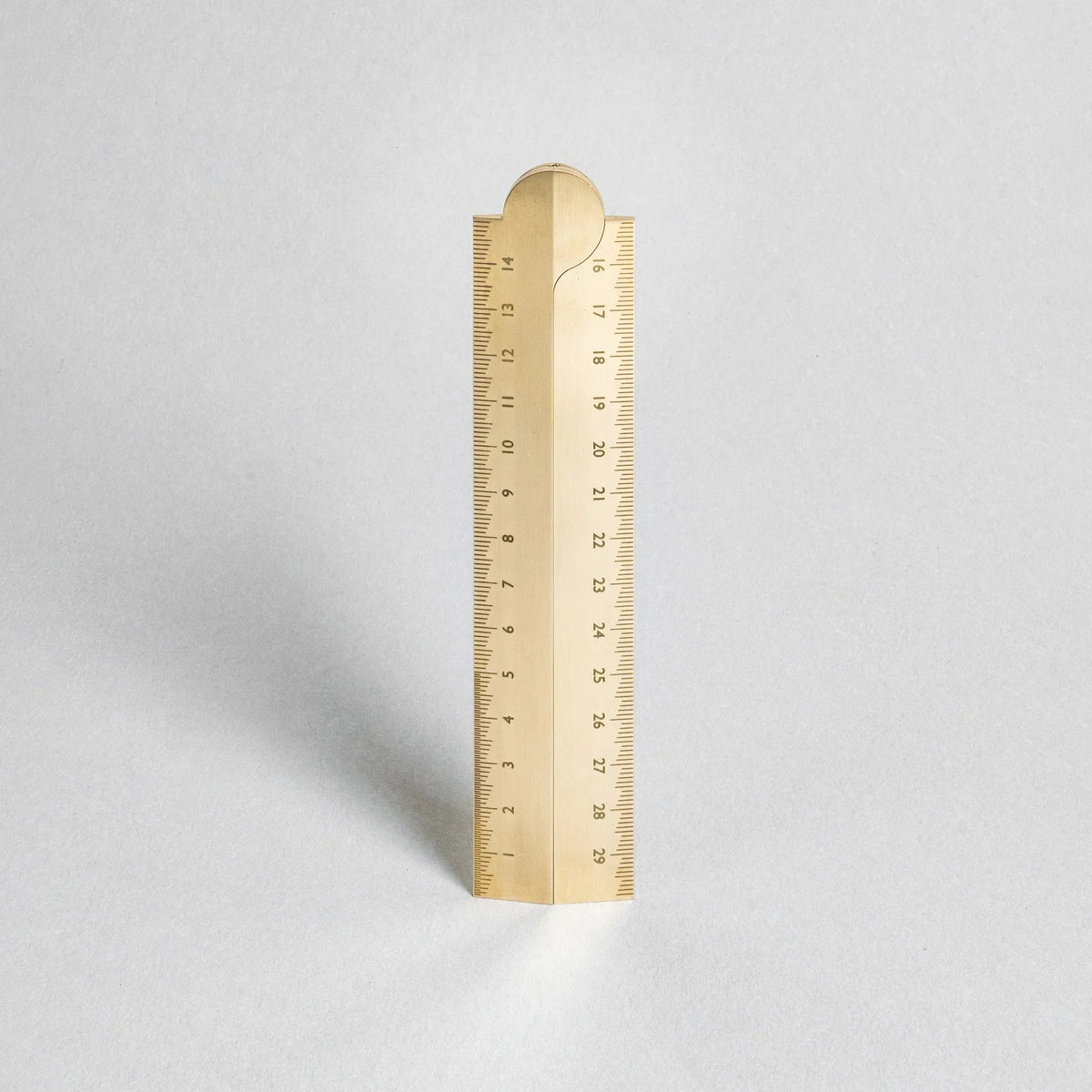 Gold ruler on a light gray background