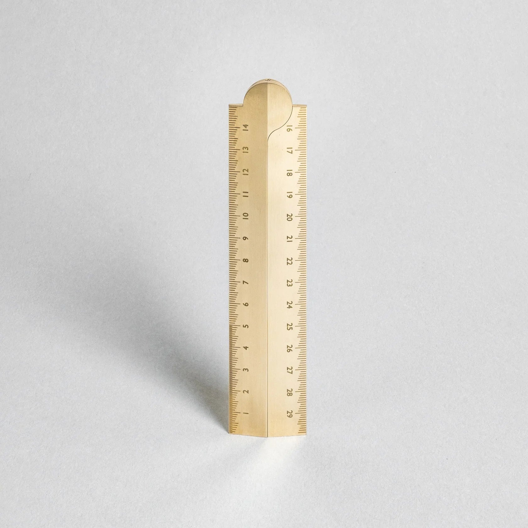 Gold ruler on a light gray background