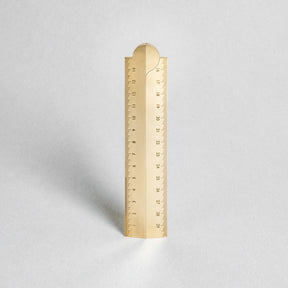 Gold ruler on a light gray background