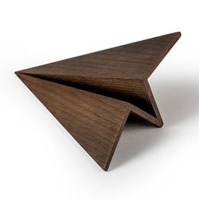 Wooden airplane like shape object from paper on a white background