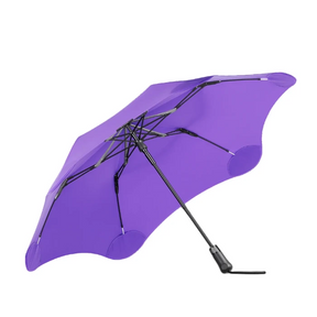 Purple umbrella with black handle and ribs on a white background