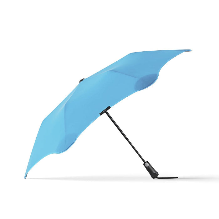 Blue umbrella with black handle on a white background