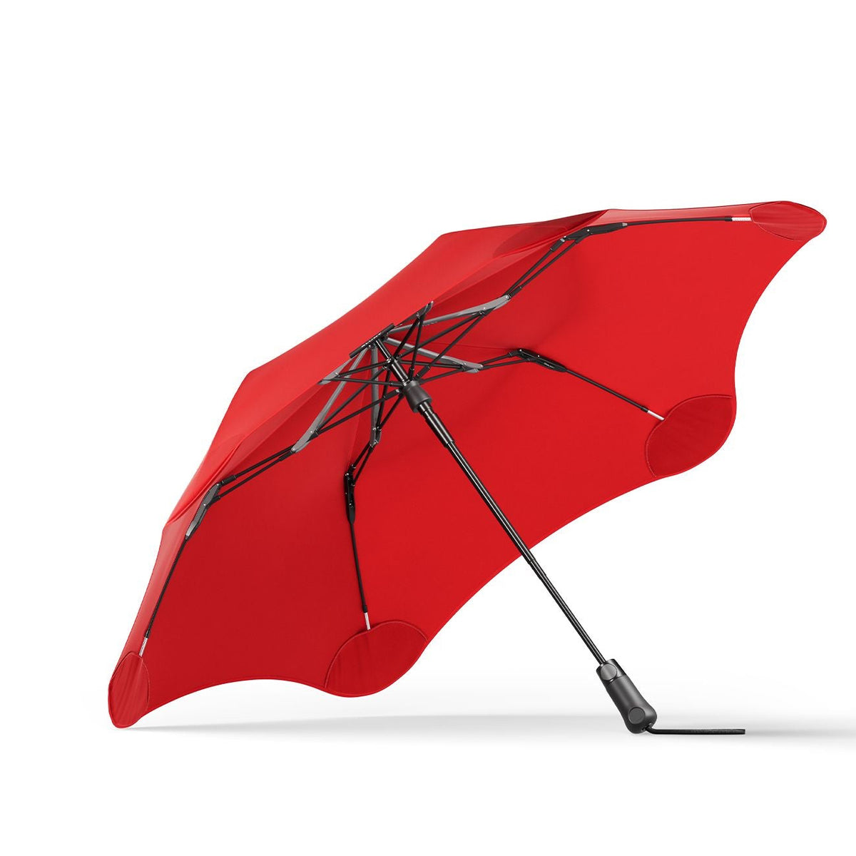 Red umbrella with black handle and ribs on a white background