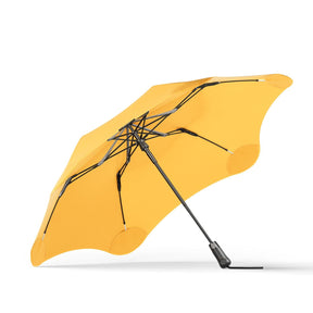 Yellow umbrella with black accents on a white background