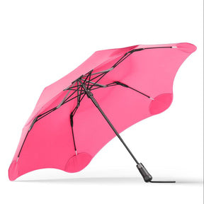 Pink umbrella with black frame on a white background