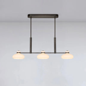 Modern pendant light with three bulbs on a plain background
