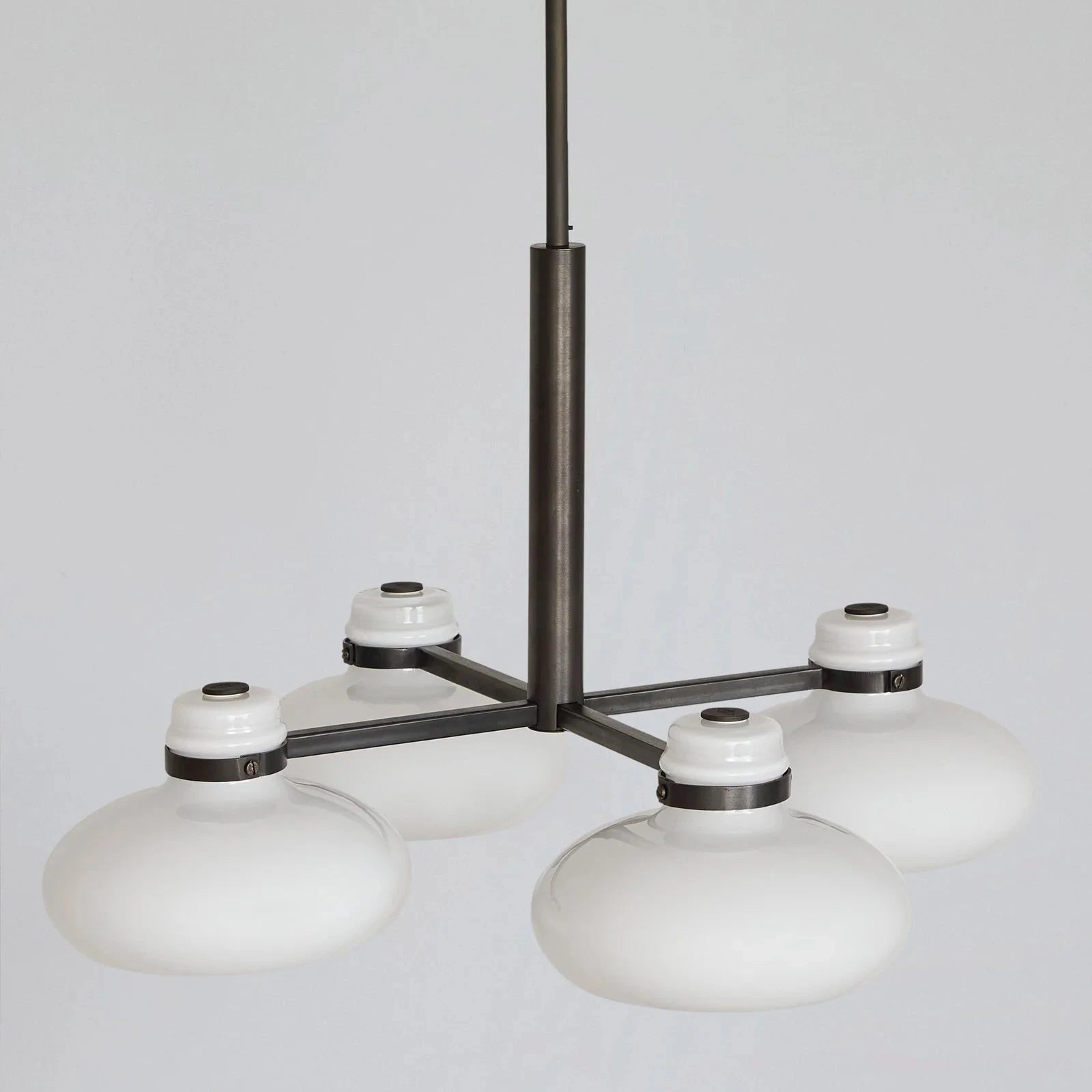Modern chandelier with white glass shades on a gray background