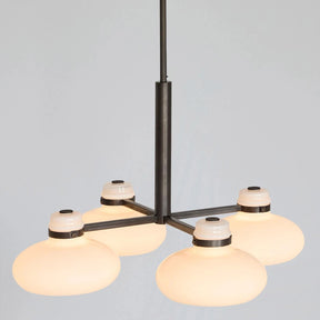 Modern chandelier with glass shades on a gray background