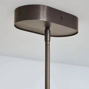 Ceiling light fixture with a dark finish on a plain background