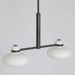 Modern pendant light with two white lampshades on a gray background