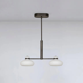 Modern pendant light with two round glass shades on a plain background