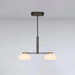 Modern pendant light with two glass shades on a plain background