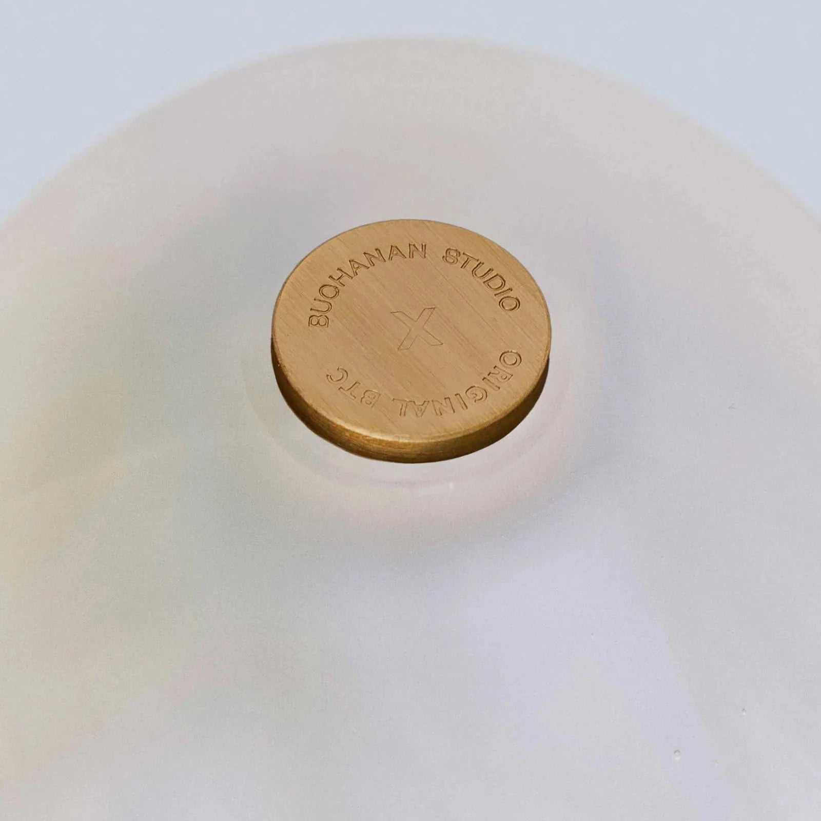 Close-up of a white ceramic bowl with a gold lid featuring 'Bloom & Co' branding.
