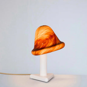 Mushroom-shaped lamp with marbled design on a white base against a light gray background