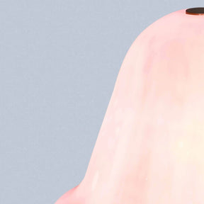Pink glass object on a light blue background