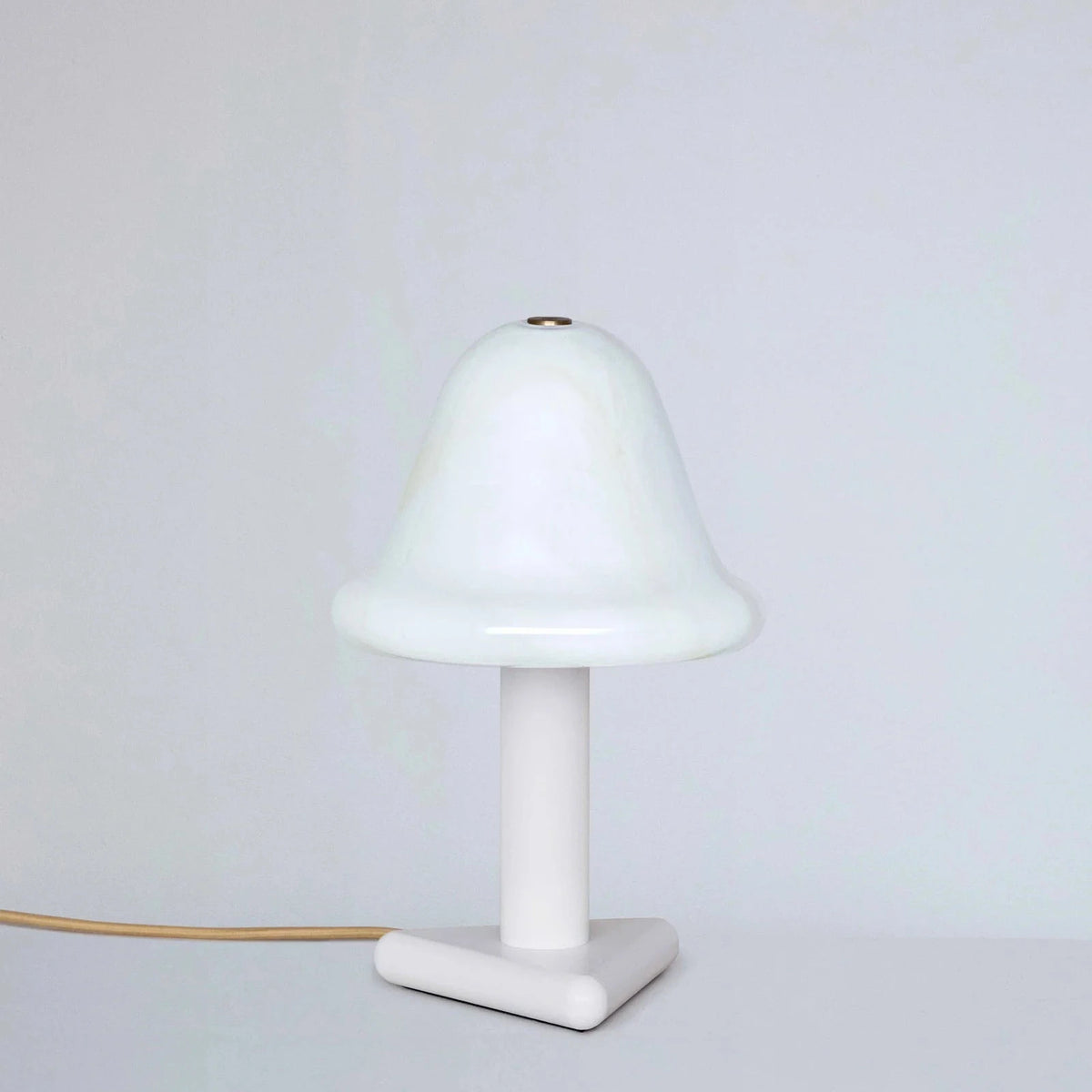White table lamp with a minimalist design on a light gray background