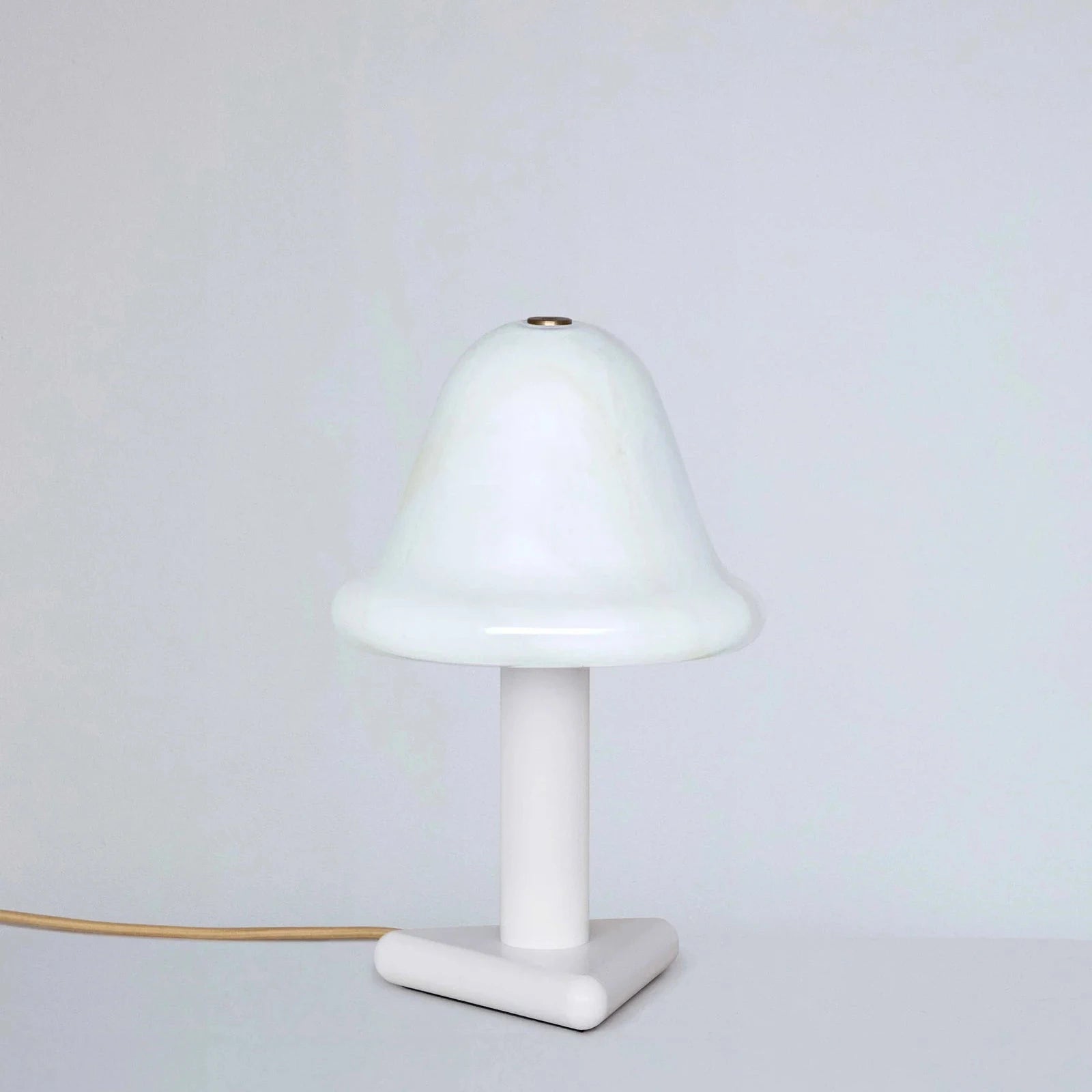 White table lamp with a minimalist design on a light gray background