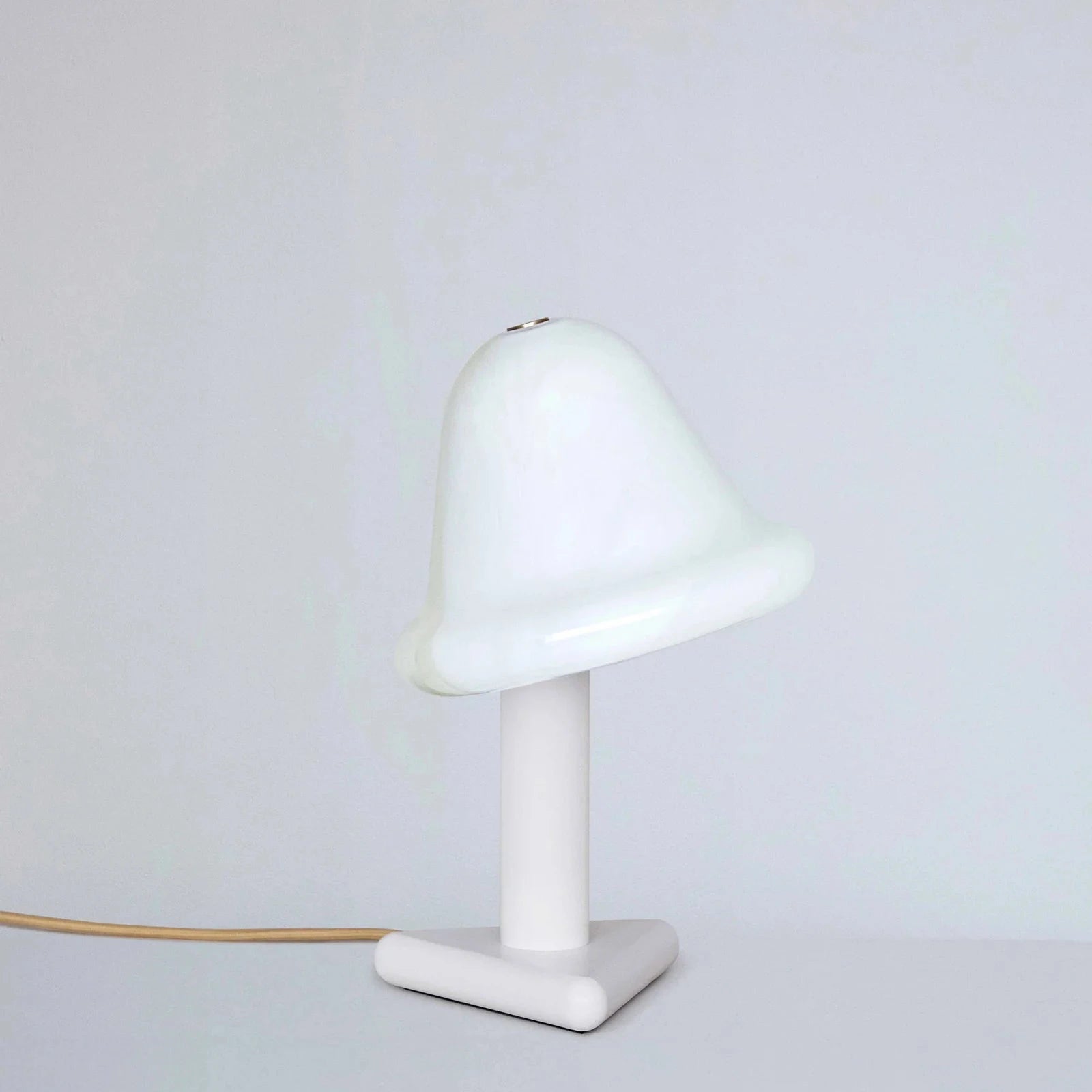 White table lamp with a cone-shaped shade on a light gray background