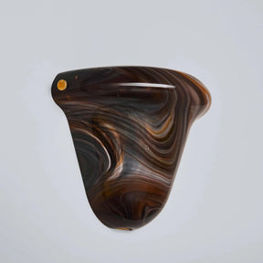 Wooden product with swirling pattern on a light gray background