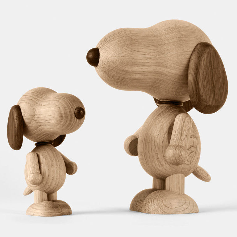 Two wooden figurines of animated cartoon characters carved from smoked oak, featuring rounded heads, contrasting darker ear and nose details, simplified bodies and limbs, visible natural wood grain, and smooth matte surfaces on a plain white background.