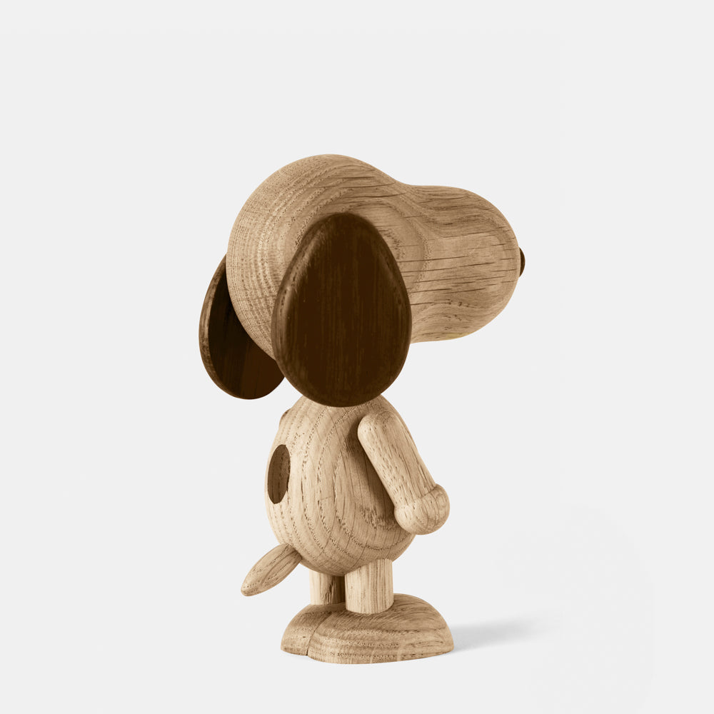 Wooden figurine of an animated cartoon character carved from smoked oak, featuring an elongated rounded head, contrasting darker ear and nose details, simplified body with subtle tail, visible natural wood grain, and a smooth matte surface on a plain white background.