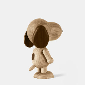 Wooden figurine of an animated cartoon character carved from smoked oak, featuring an elongated rounded head, contrasting darker ear and nose details, simplified body with subtle tail, visible natural wood grain, and a smooth matte surface on a plain white background.
