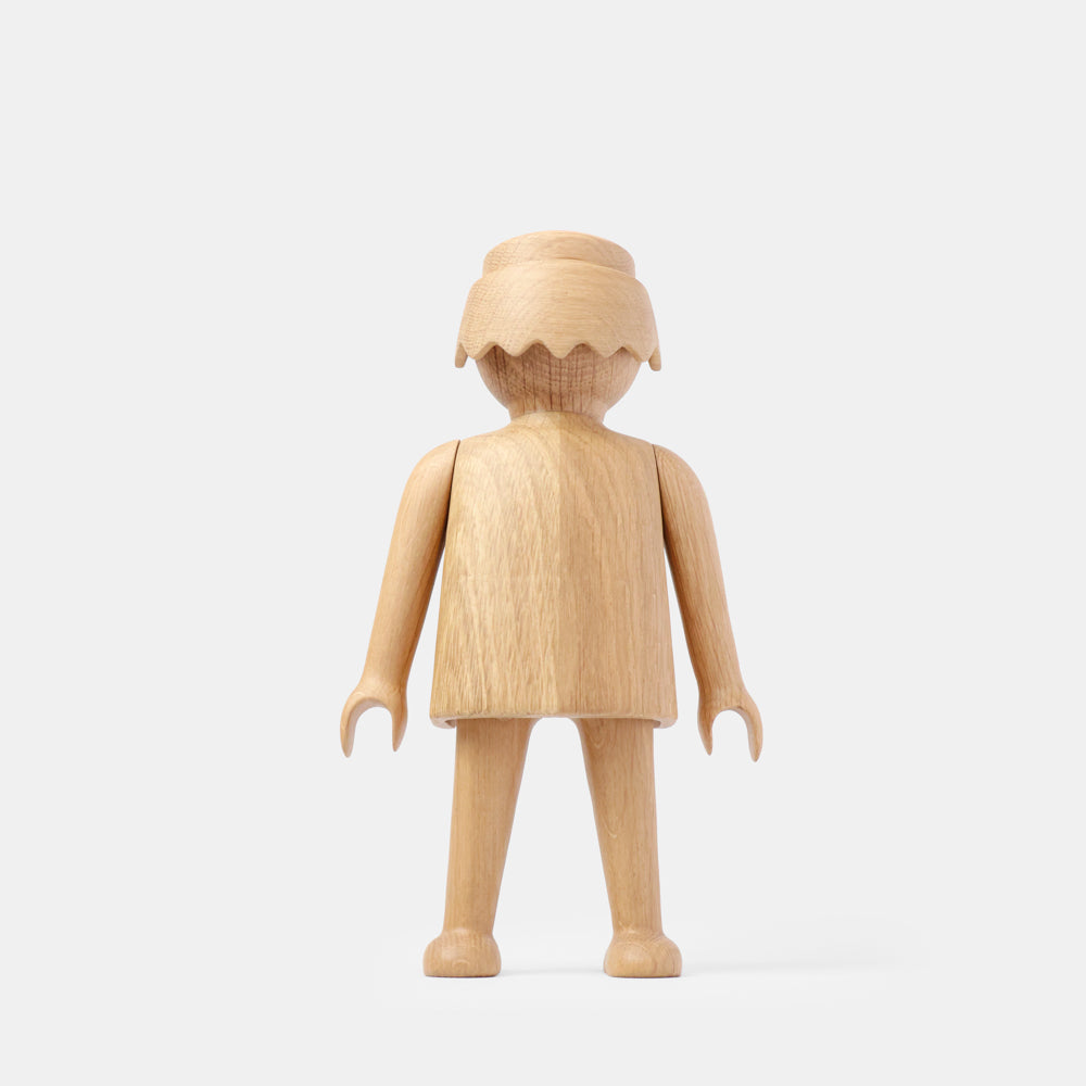 Wooden Playmobil-style human figure crafted from light oak, featuring a rounded head with carved hair detail, smooth sculpted torso and arms, visible natural wood grain, and a matte surface on a plain white background.