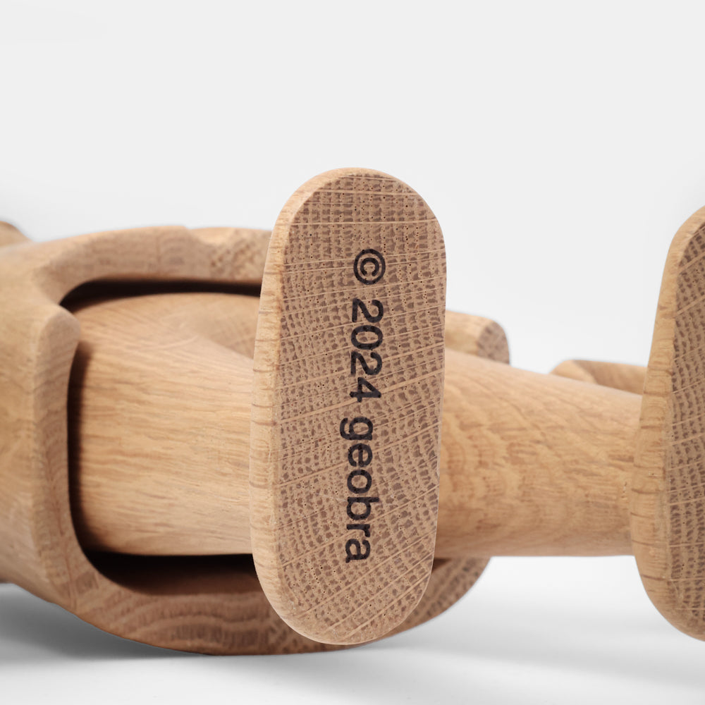 Wooden toy with '2024 geobra' branding on a white background