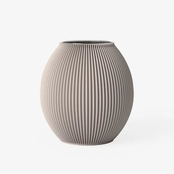A ribbed ceramic vase in a warm taupe-beige color, featuring vertical fluted ridges and a rounded, bulbous shape, set against a plain white background.