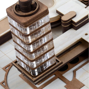 Wooden model of a tower with glass panels on a tiled floor