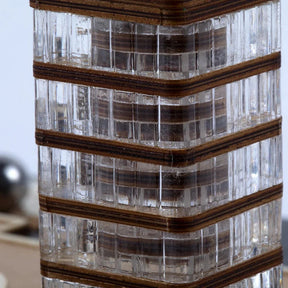 Decorative vase with ribbed design and wooden accents on a blurred background