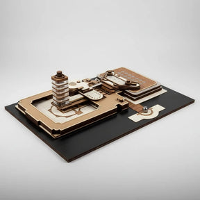 Wooden mechanical model on a black base with a white background