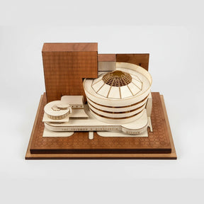 Wooden model of a building with a wooden box on a white background