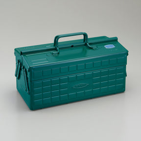 Antique green Toyo steel cantilever toolbox, closed, three-quarter view showing embossed grid panels, folded side arms, and integrated top carry handle.