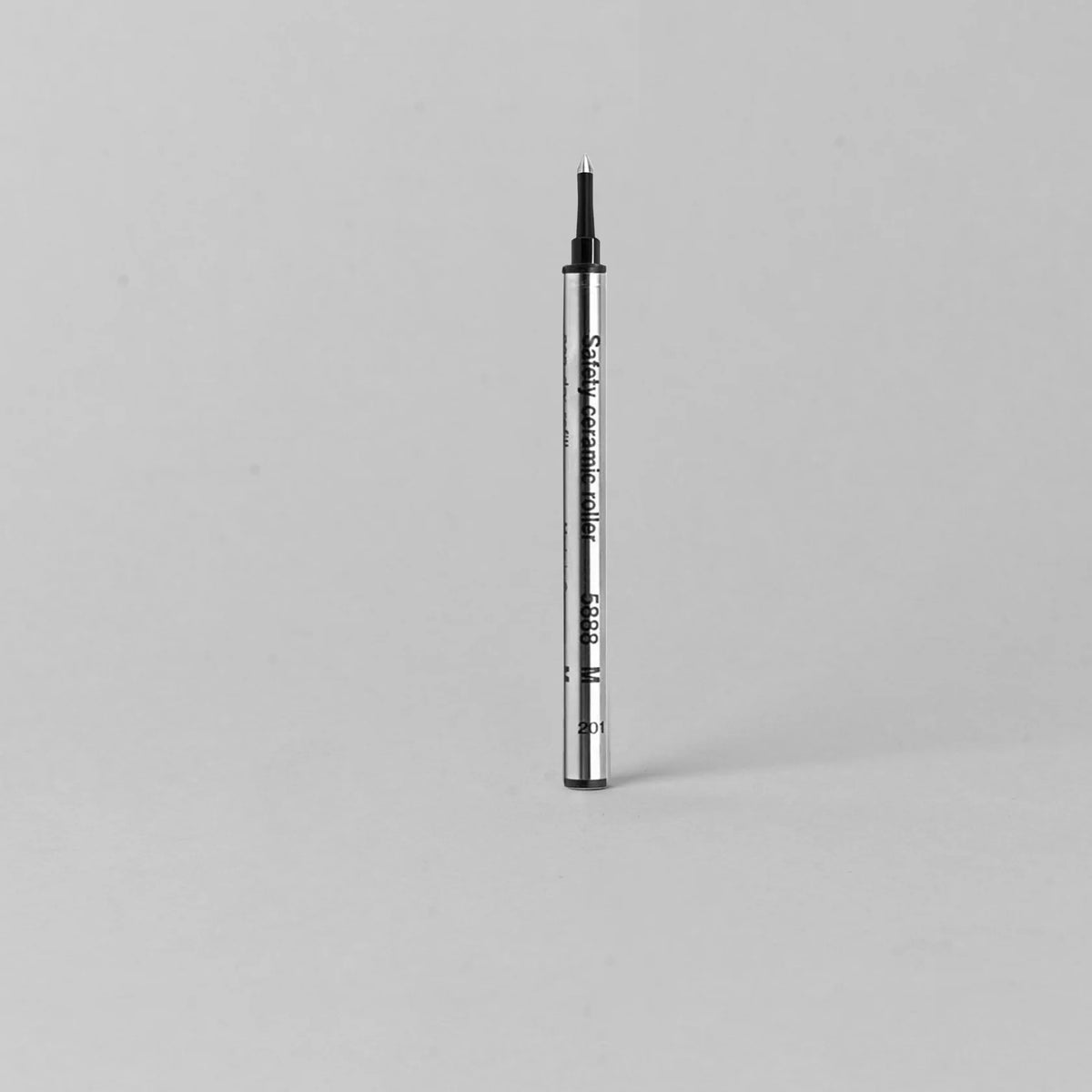 silver body refillable pen on a gray background