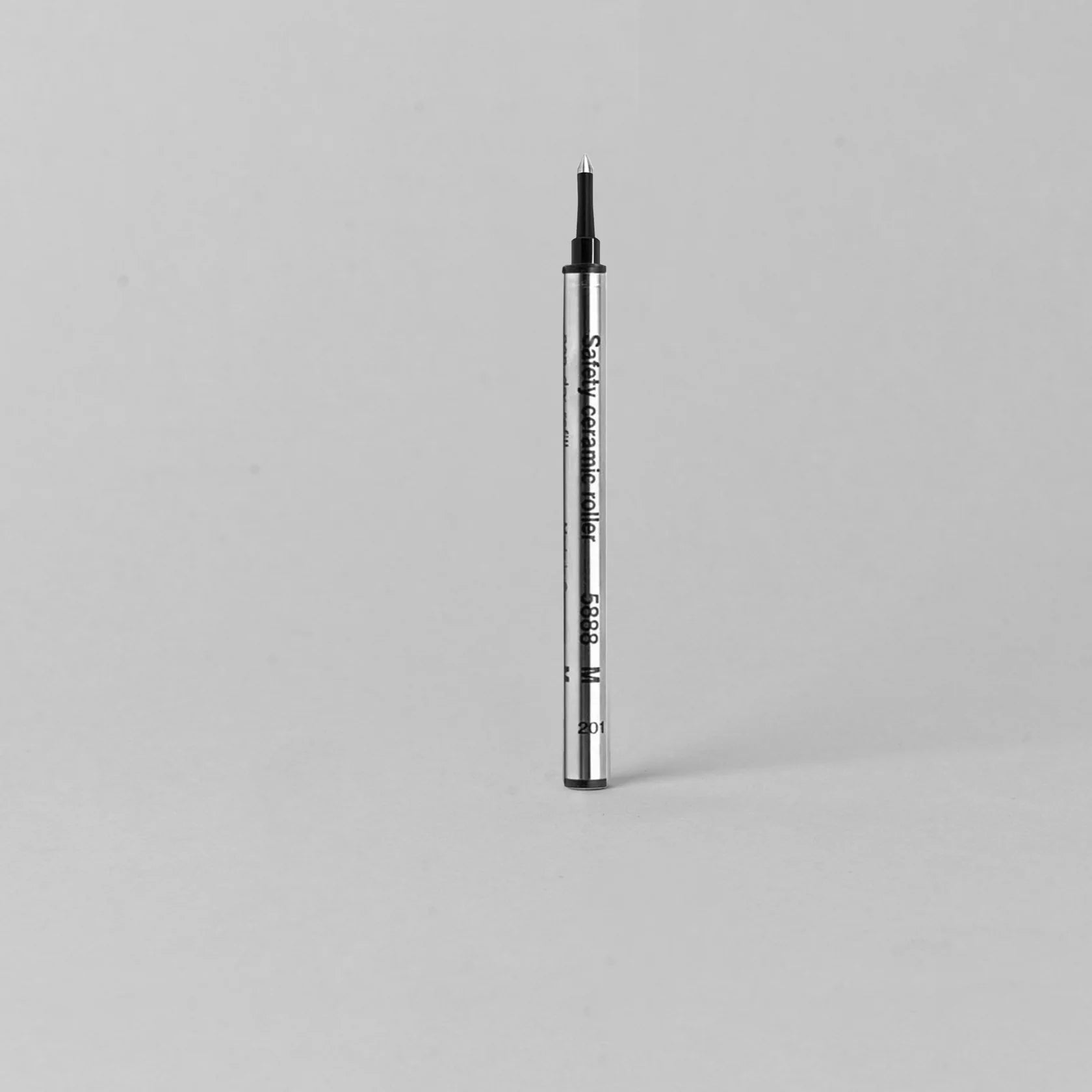 silver body refillable pen on a gray background