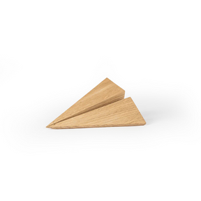 Angular wooden object crafted from light oak, featuring sharp folded planes, clean geometric lines, visible natural wood grain, and a smooth matte surface on a plain white background.