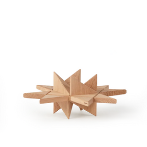Geometric star-shaped wooden object crafted from light oak, formed by intersecting flat planes and pointed facets, highlighting clean lines, natural wood grain, and a smooth matte finish on a plain white background.