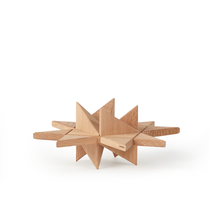 Geometric star-shaped wooden object crafted from light oak, formed by intersecting flat planes and pointed facets, highlighting clean lines, natural wood grain, and a smooth matte finish on a plain white background.