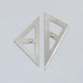 Two metallic square rulers on a light gray background