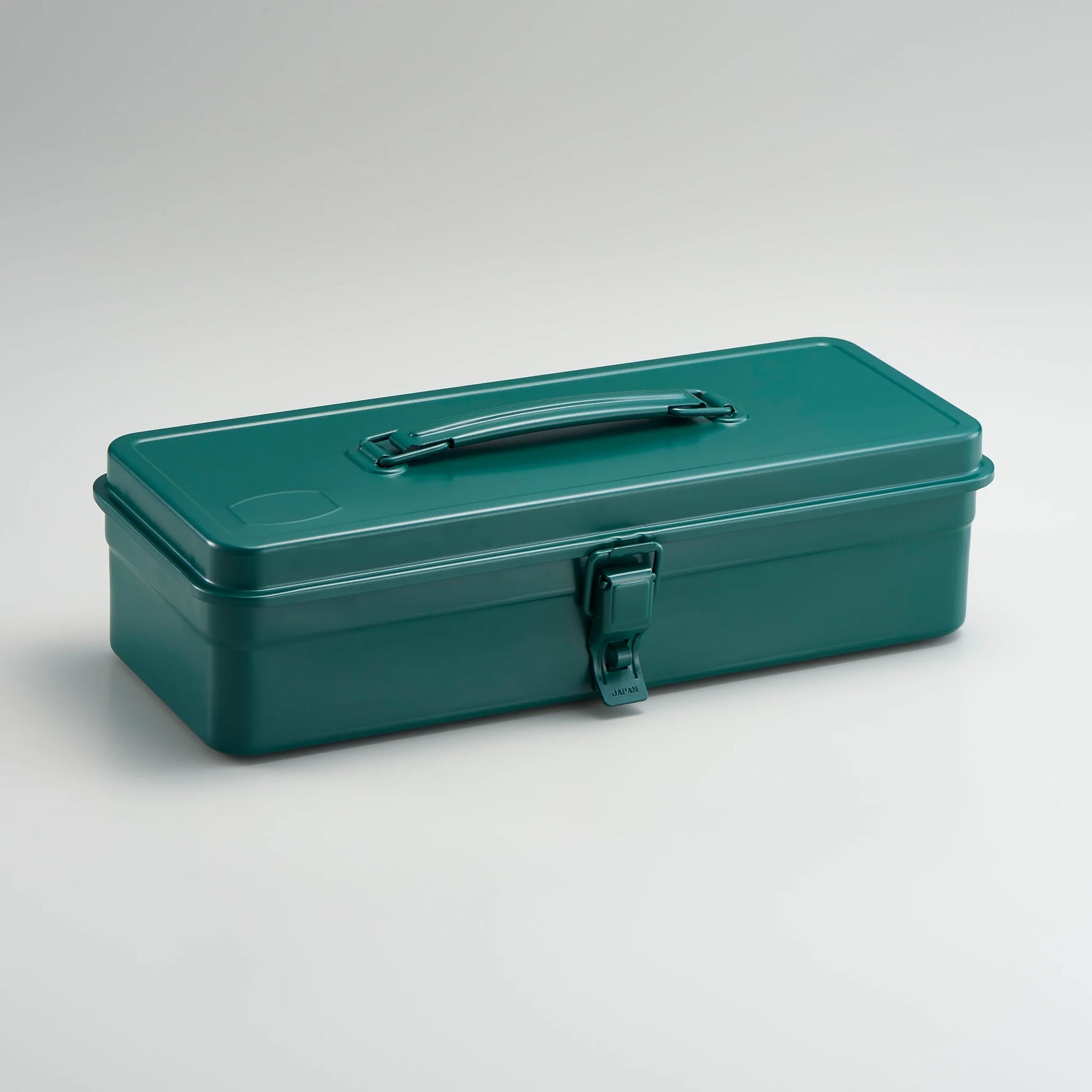 Antique green Toyo Steel metal toolbox with smooth rectangular design, top carry handle, and single front latch, photographed closed against a neutral light gray background.