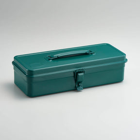 Antique green Toyo Steel metal toolbox with smooth rectangular design, top carry handle, and single front latch, photographed closed against a neutral light gray background.