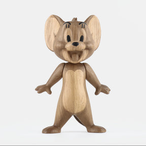 Wooden figurine of an animated cartoon mouse character carved from light-toned wood, featuring large rounded ears, expressive facial details, outstretched arms, simplified body proportions, visible natural wood grain, and a smooth matte surface on a plain white background.