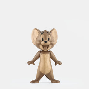 Wooden figurine of an animated cartoon mouse character carved from light-toned wood, featuring large rounded ears, expressive facial details, outstretched arms, simplified body proportions, visible natural wood grain, and a smooth matte surface on a plain white background.