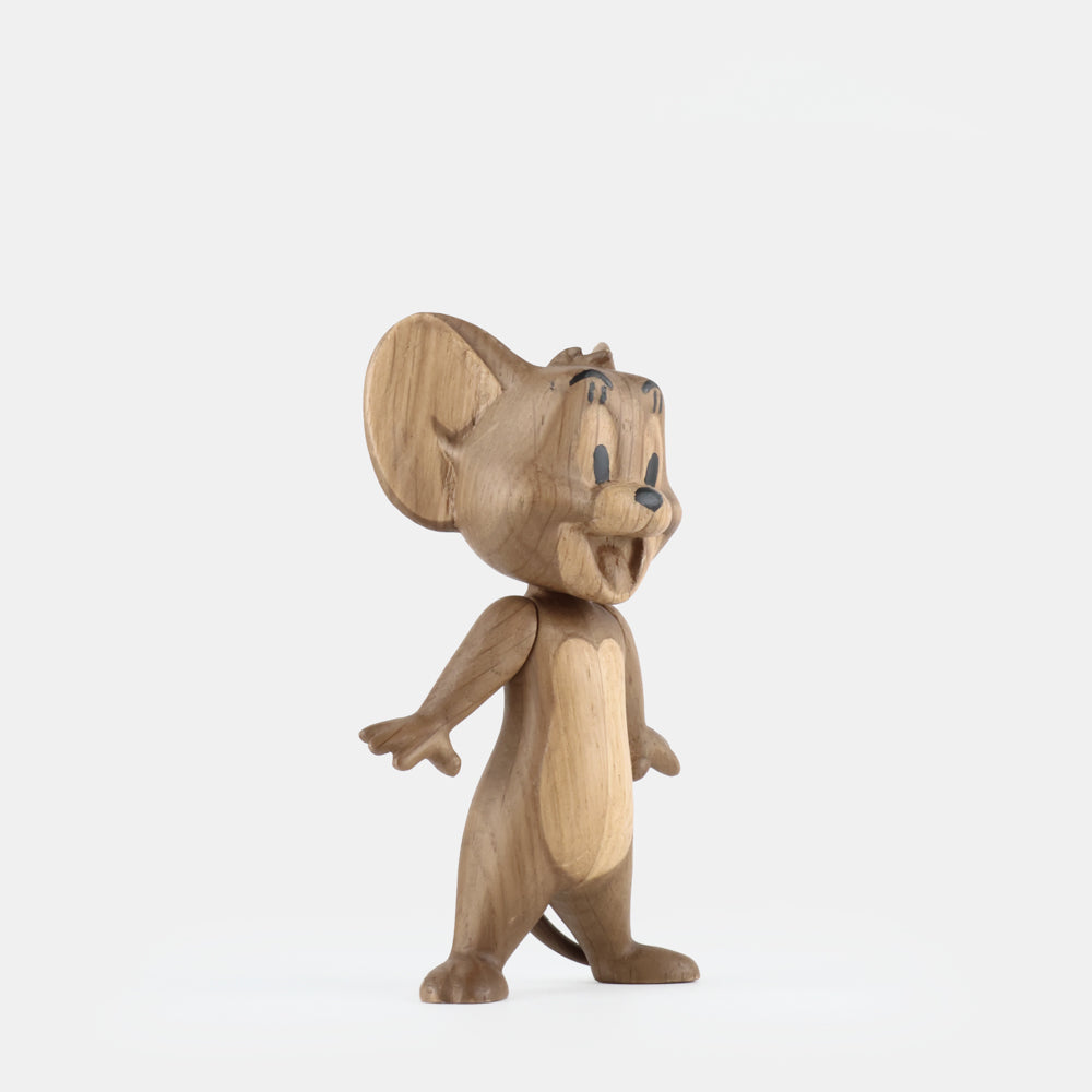 Wooden figurine of an animated cartoon mouse character carved from light-toned wood, featuring large rounded ears, expressive facial details, outstretched arms, a standing pose, visible natural wood grain, and a smooth matte surface on a plain white background.
