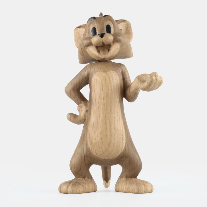 Wooden figurine of an animated cartoon mouse character, carved from light-toned wood, featuring expressive facial details, rounded ears, a standing pose with one hand raised, visible wood grain, and a smooth matte surface on a plain white background.