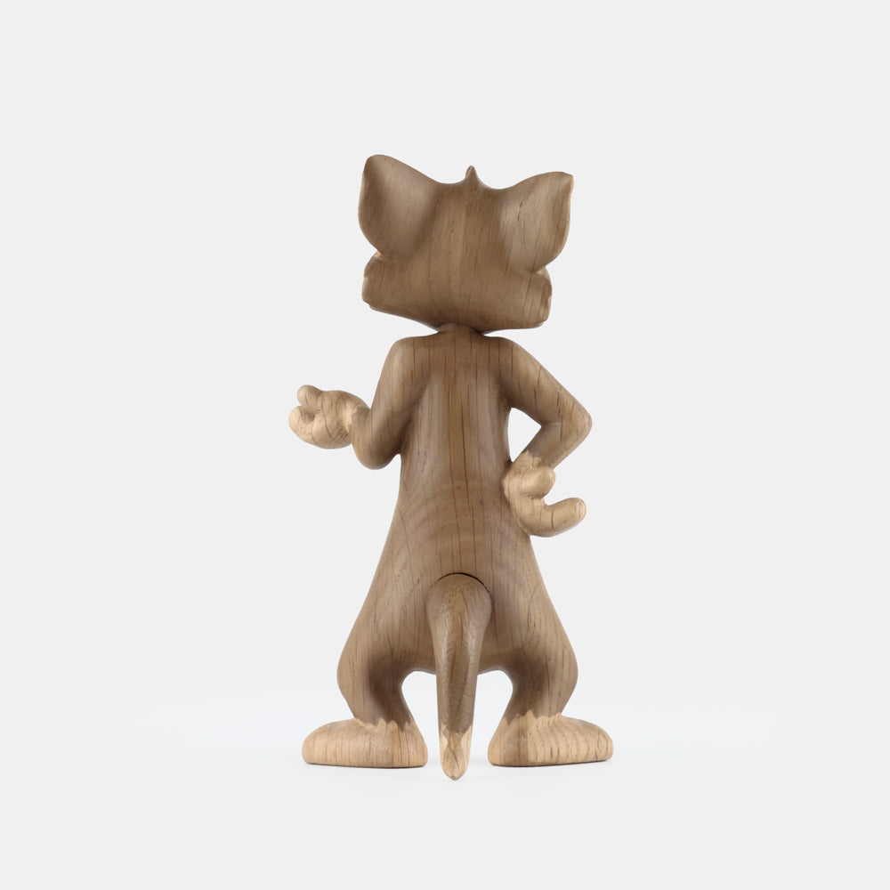 Wooden figurine of an animated cartoon mouse character, carved from light-toned wood, featuring expressive facial details, rounded ears, a standing pose with one hand raised, visible wood grain, and a smooth matte surface on a plain white background.