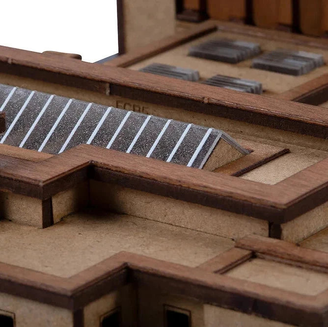 Close-up of a wooden model with solar panels on a white background