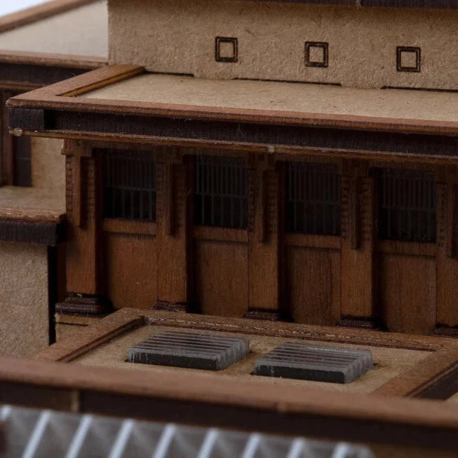 Close-up of a wooden model building with detailed architecture.